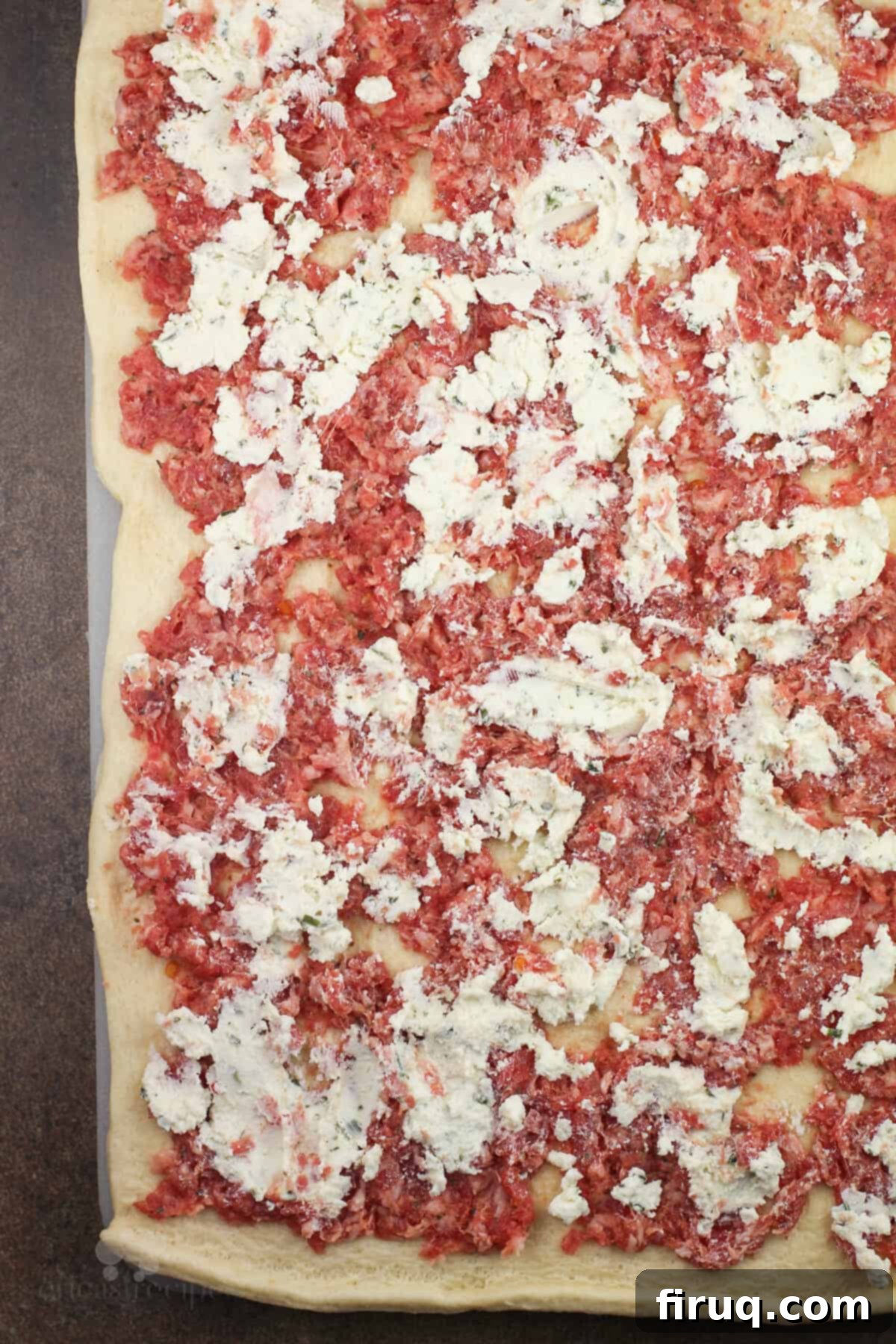 Creamy Boursin Sausage Swirls 4 Crescent dough laid flat, generously spread with uncooked breakfast sausage and creamy Boursin Garlic & Fine Herbs cheese.