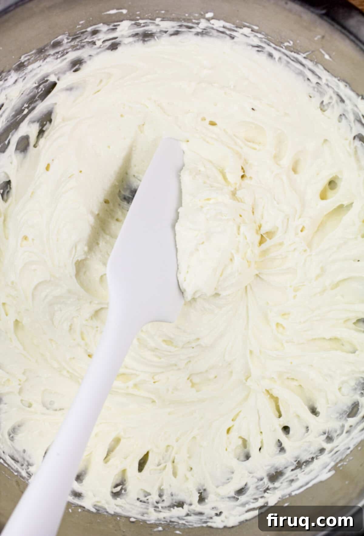 Zesty Lemon Bliss 5 white spatula in glass bowl with cream cheese layer mixture