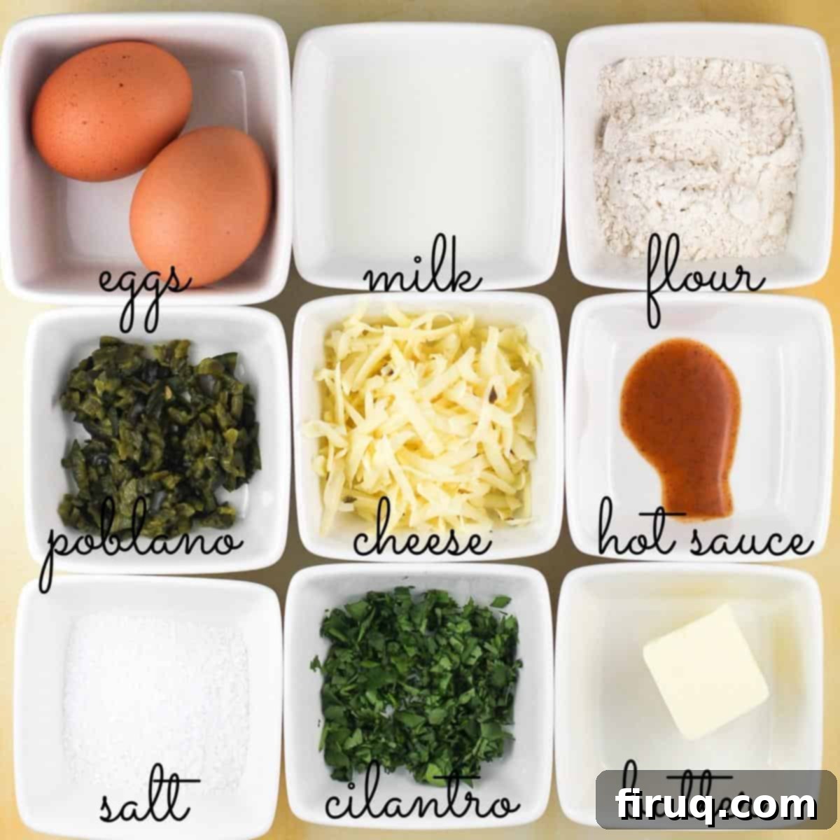 Poblano Cloud Bites 4 A neatly organized collection of popover ingredients, each separated and labeled in small white bowls, ready for mixing, including eggs, milk, flour, and pepperjack cheese.