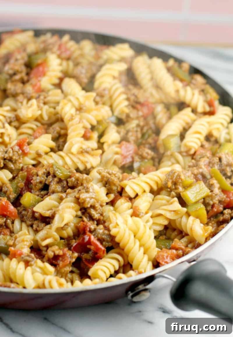 Homestyle Beef & Macaroni Bake 8 side view of the fully assembled sloppy joe dinner in a skillet placed on white marble, ready to serve