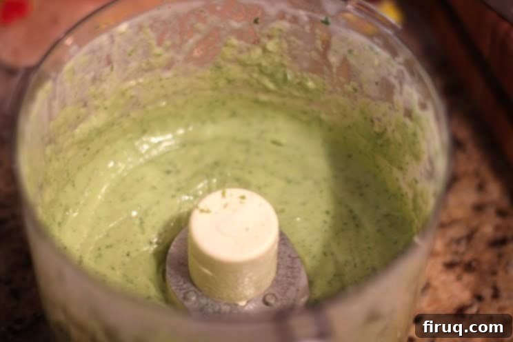 Fresh Herb Avocado Elixir 5 Avocado Herb Dressing in a small white bowl with a spoon