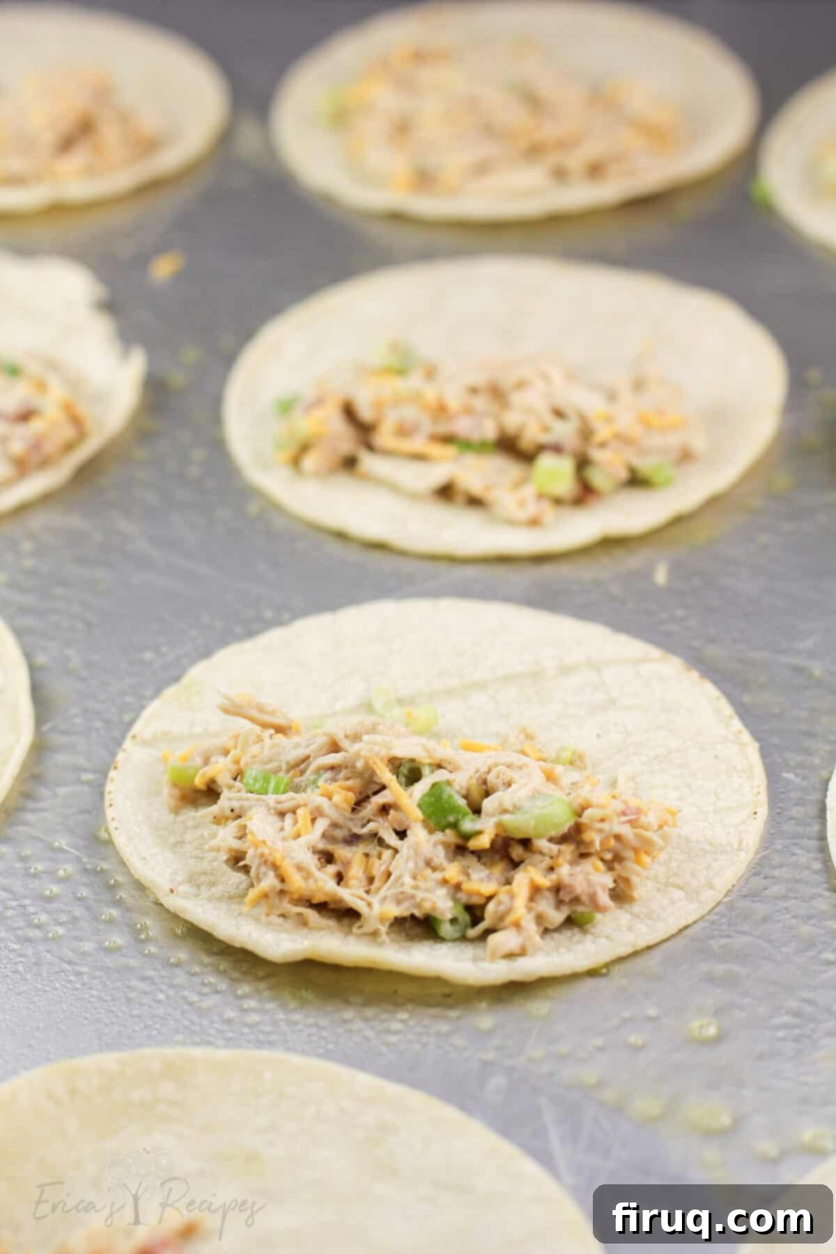 Crispy Mini Air Fryer Chicken Quesadilla 4 tortilla on bake sheet topped with chicken filling