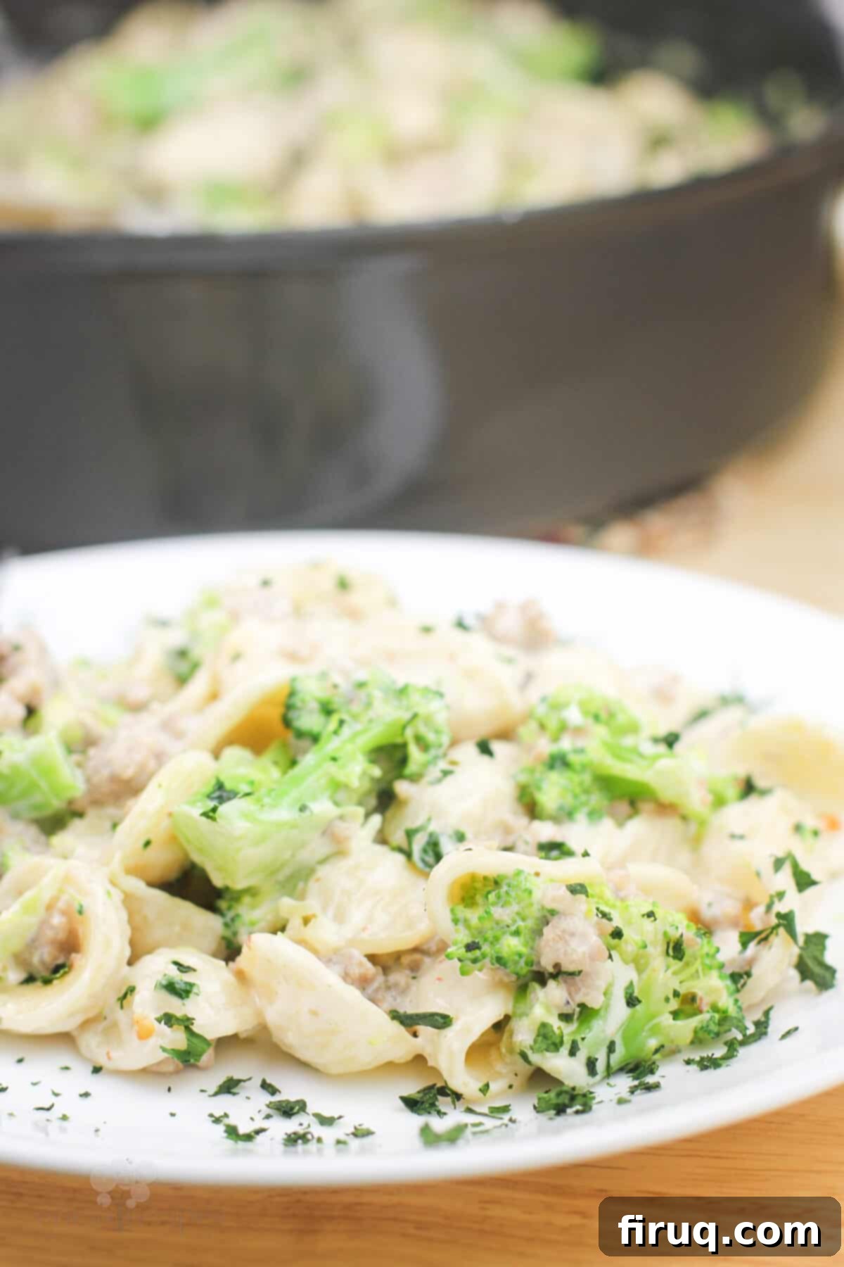 Sausage and Broccoli Orecchiette 4 A perfectly portioned serving of creamy broccoli and sausage orecchiette pasta on a white plate, ready to be enjoyed.
