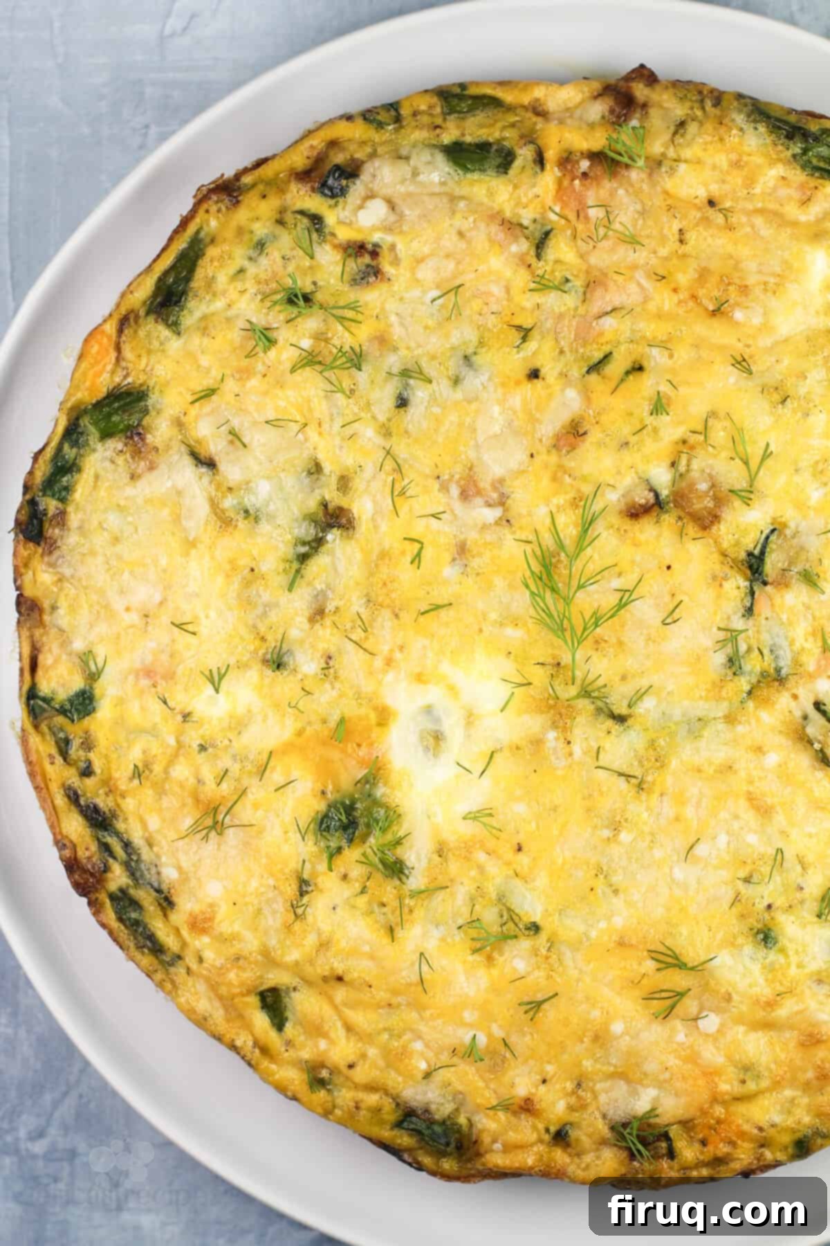 Savory Smoked Salmon and Vegetable Frittata 3 cooked whole frittata on white plate