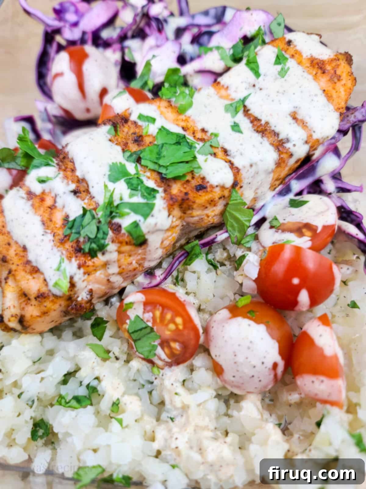 Spicy Chipotle Salmon and Cauliflower Rice Meal Prep 4 cauliflower rice topped with cherry tomatoes and creamy chipotle dressing