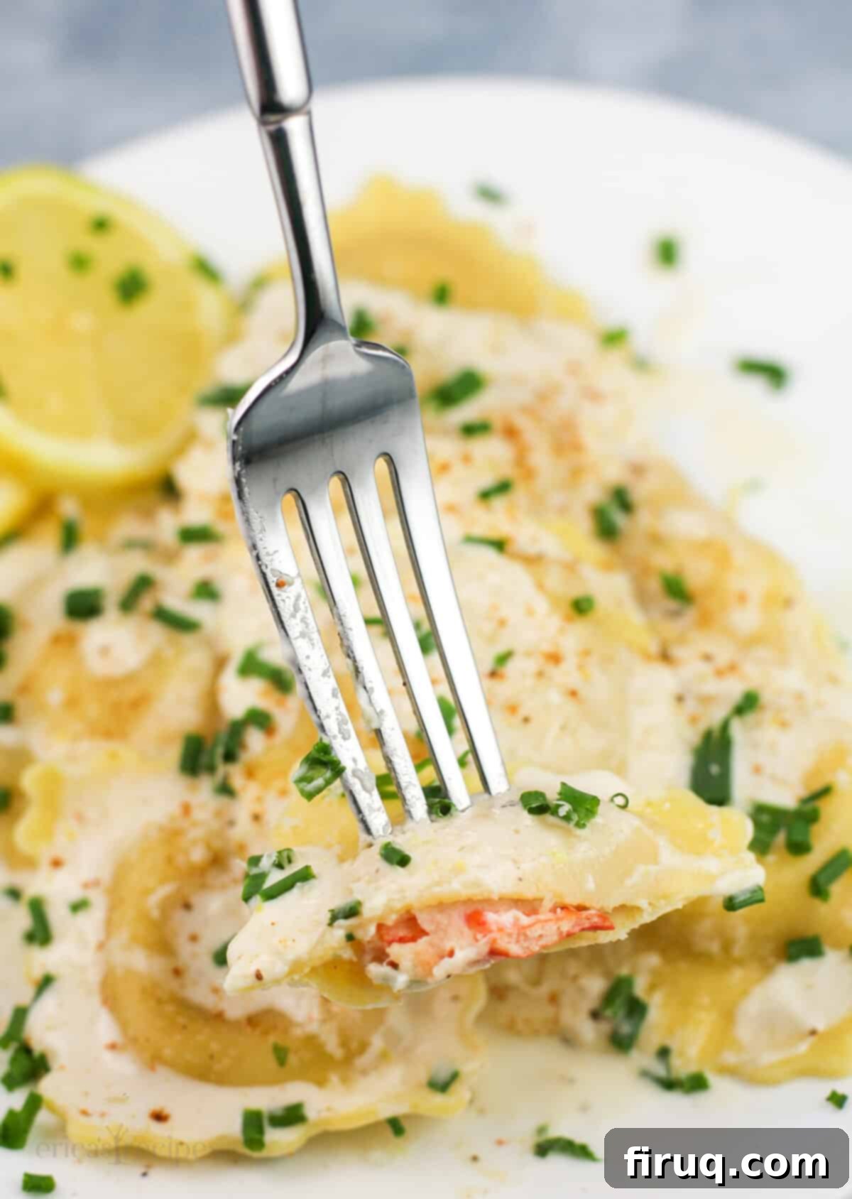 Bright Lemon Garlic Cream for Lobster Ravioli 4 fork holding piece of lobster ravioli