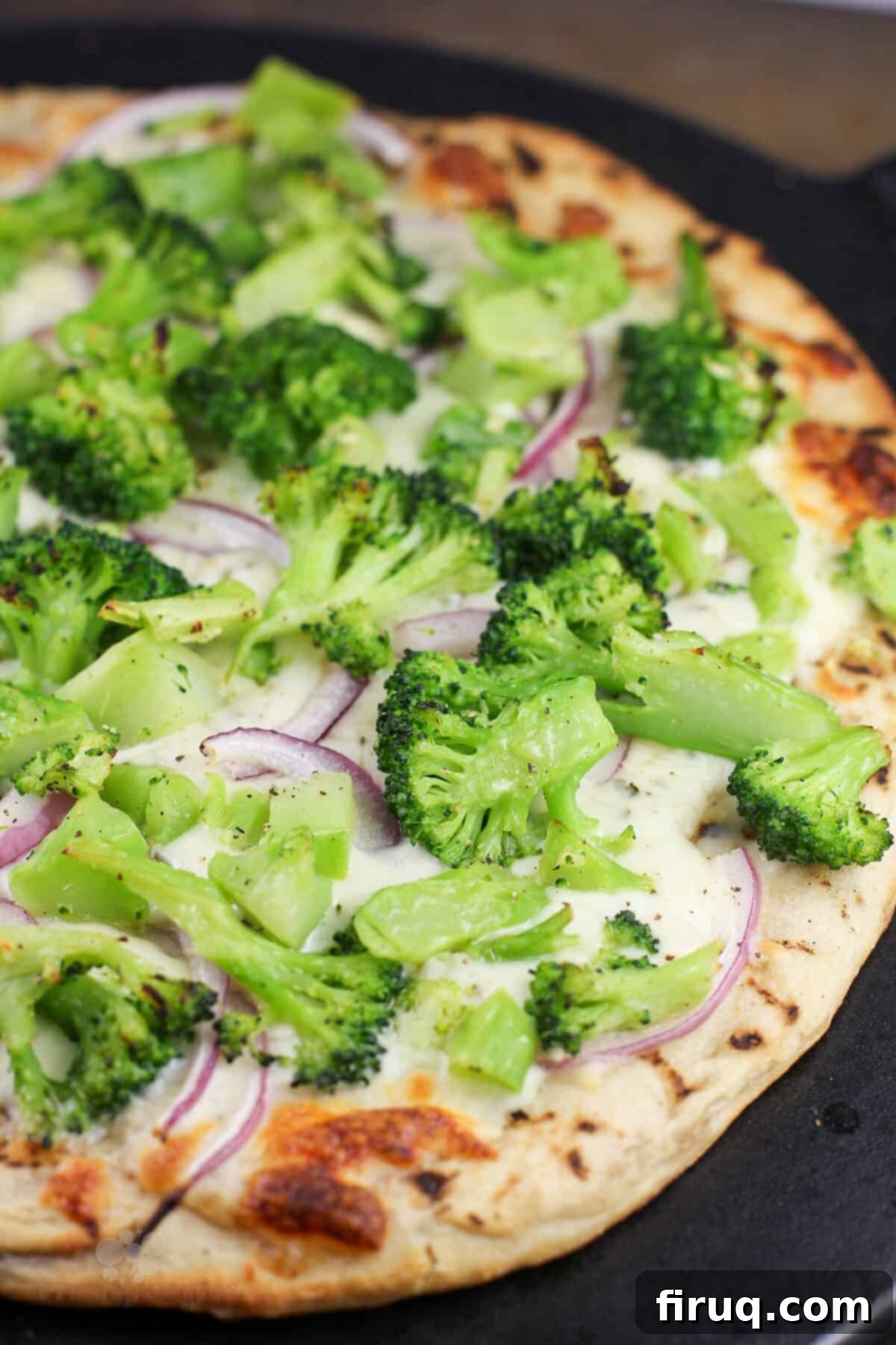 Creamy Broccoli Pizza 9 cooked pizza on black stone, right out of the oven before adding last ingredients