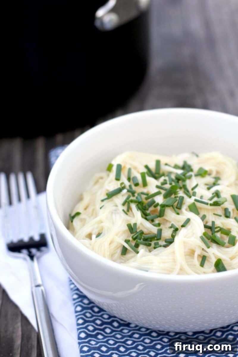 Velvety Sour Cream and Chive Pasta 2 finished pasta roni in this bowl topped with chives on blue napkin next to a fork