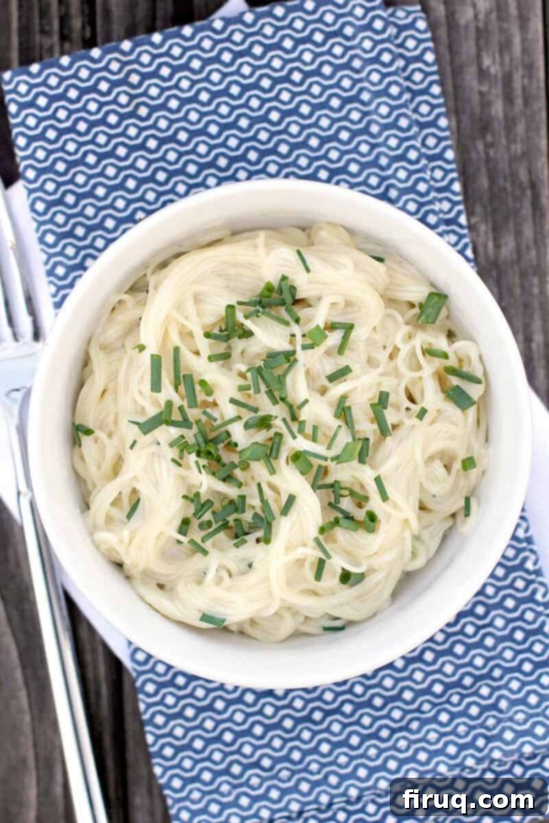 Velvety Sour Cream and Chive Pasta 3 top down view into bowl with pasta on napkin by a fork
