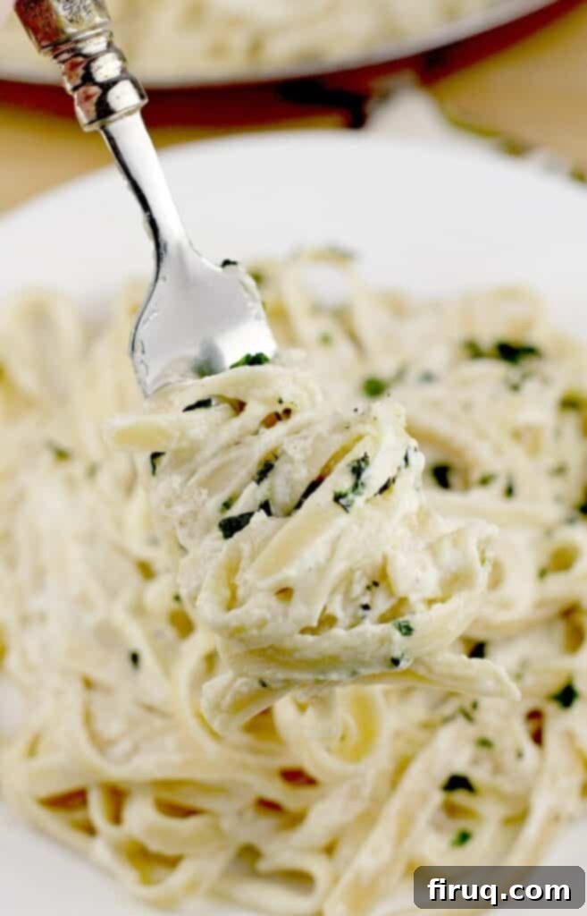 Velvety Sour Cream and Chive Pasta 8 a fork with pasta wrapped around it