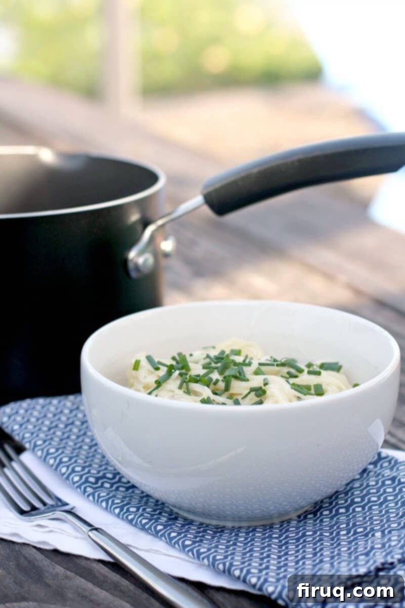 Velvety Sour Cream and Chive Pasta 9 white bowl and black saucepan on picnic table