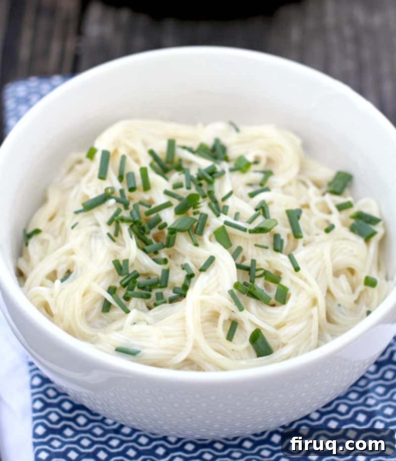 Velvety Sour Cream and Chive Pasta 10 close view of sour cream and chive pasta in white bowl