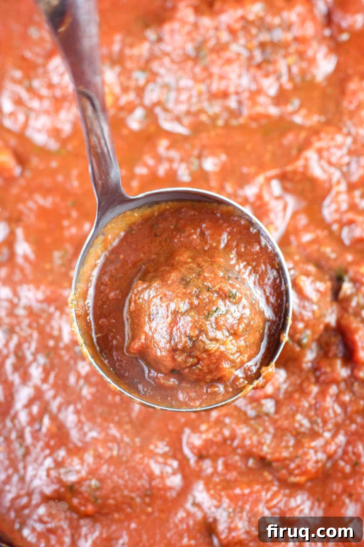 Smoky Meatballs in Tangy Marinara 3 ladle holding a meatball and marinara