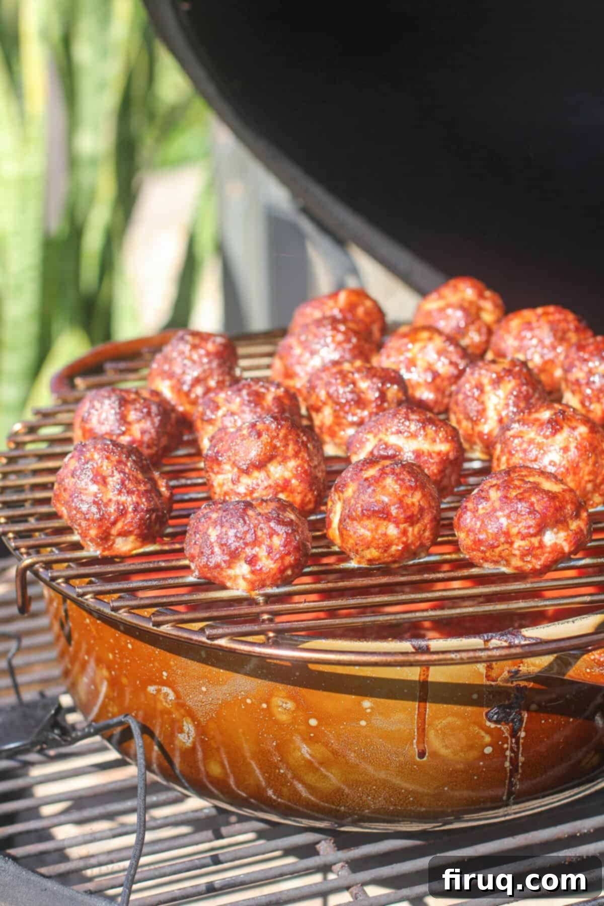 Smoky Meatballs in Tangy Marinara 7 cooked meatballs on rack on dutch oven in big green egg