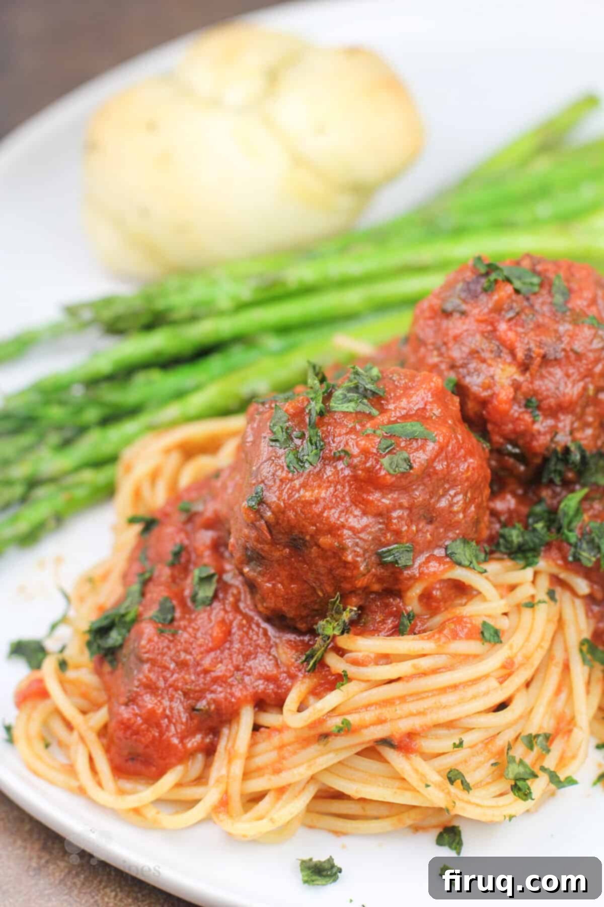 Smoky Meatballs in Tangy Marinara 9 plated recipe on white dish with asparagus