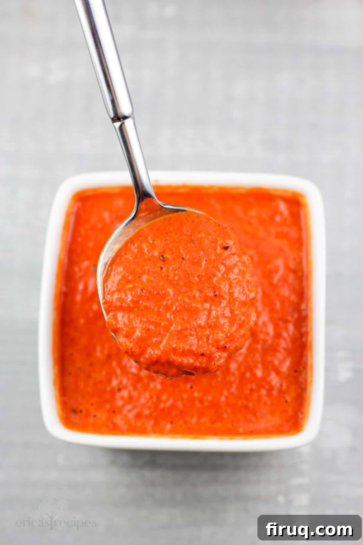 Roasted Red Pepper Coulis 3 spoon holding coulis in small white bowl