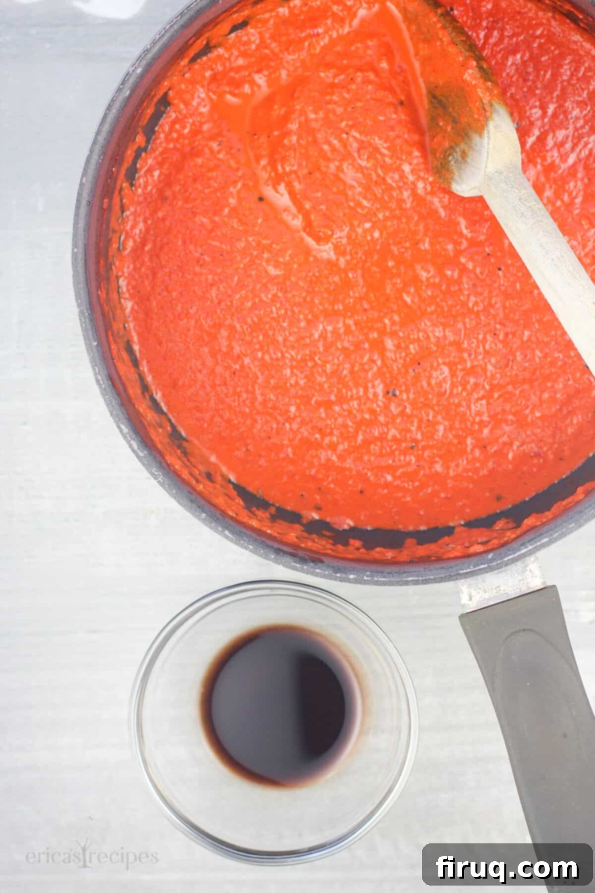Roasted Red Pepper Coulis 8 red pepper sauce in saucepan with wood spoon, small glass bowl with balsamic vinegar off to the side