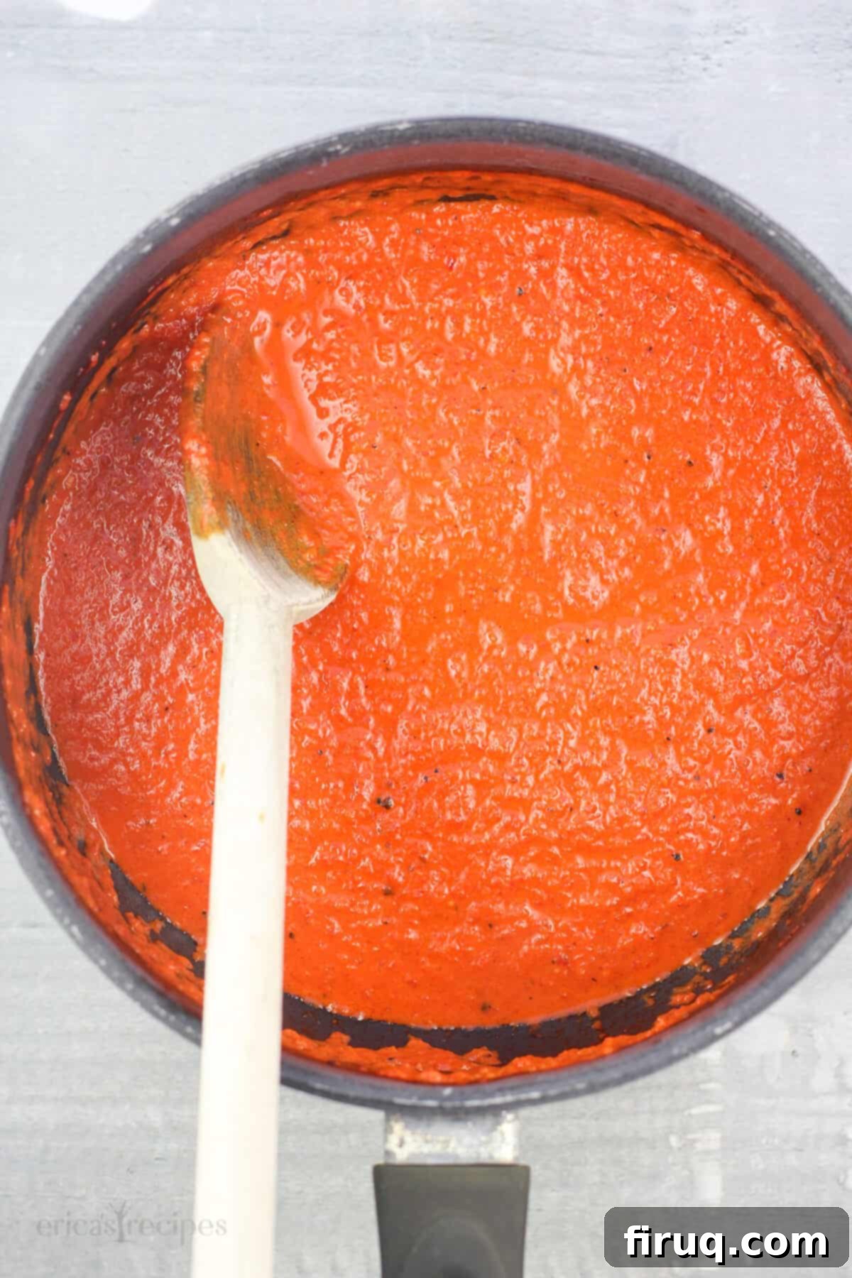 Roasted Red Pepper Coulis 9 red pepper sauce in saucepan with wood spoon