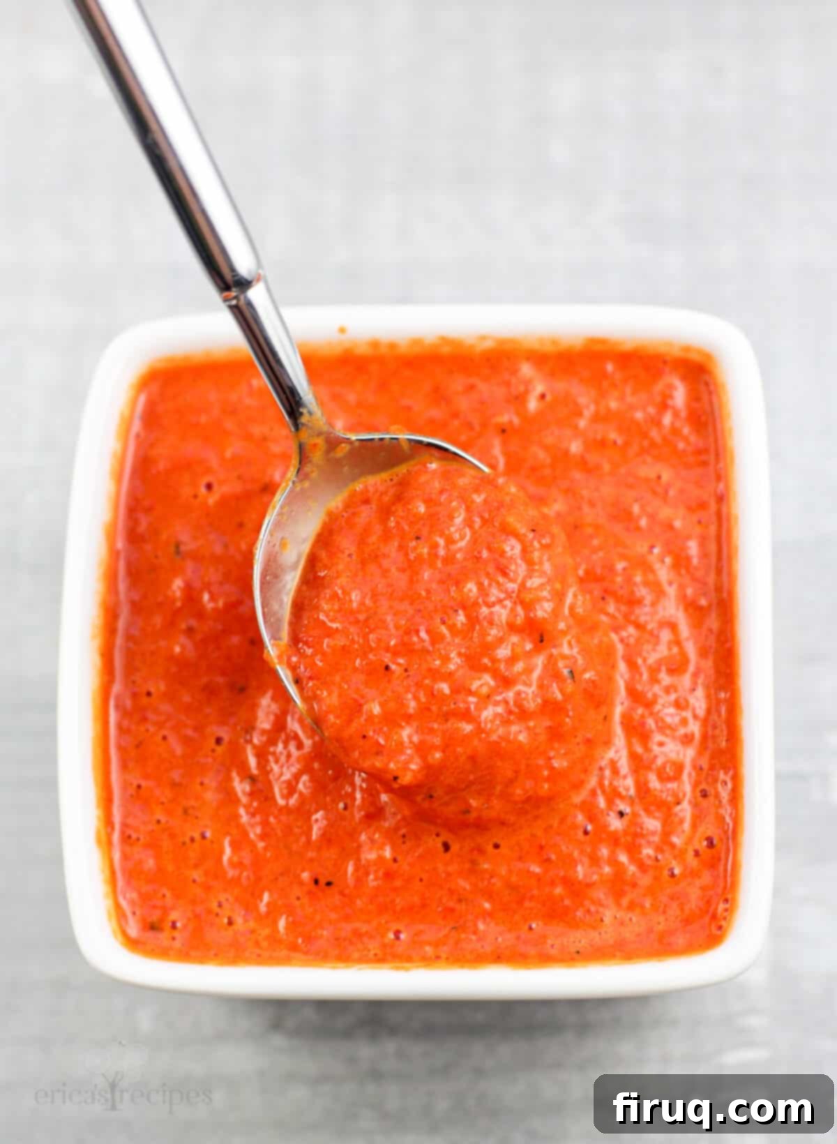Roasted Red Pepper Coulis 10 spoon holding coulis in small white bowl