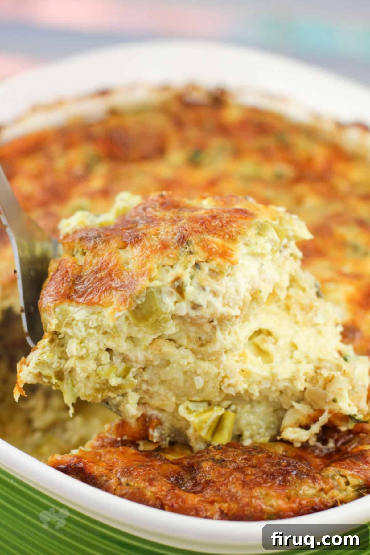 Zesty Green Chile Egg Delight 3 A spatula lifting a serving of the baked Green Chile Egg Casserole from the dish.