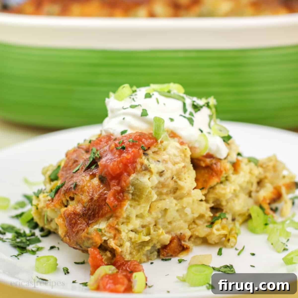 Zesty Green Chile Egg Delight 8 green chile egg casserole on white plate topped with garnish; green casserole dish in background