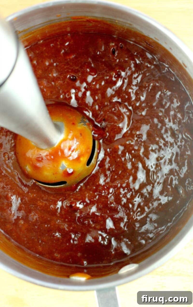 Sweet Heat Cherry Chipotle BBQ 9 immersion blender in a pan blending sauce