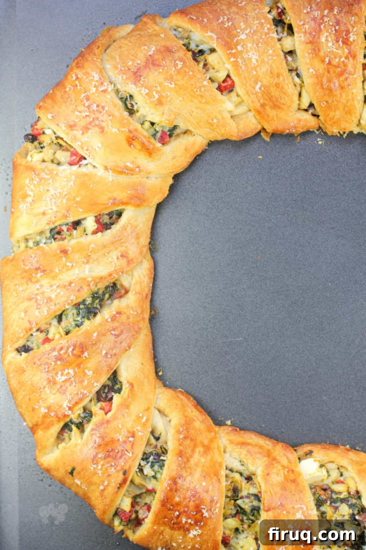 Mediterranean Crescent Wreath 3 Finished Mediterranean crescent ring, sliced and showing the vibrant filling, displayed on a bake sheet