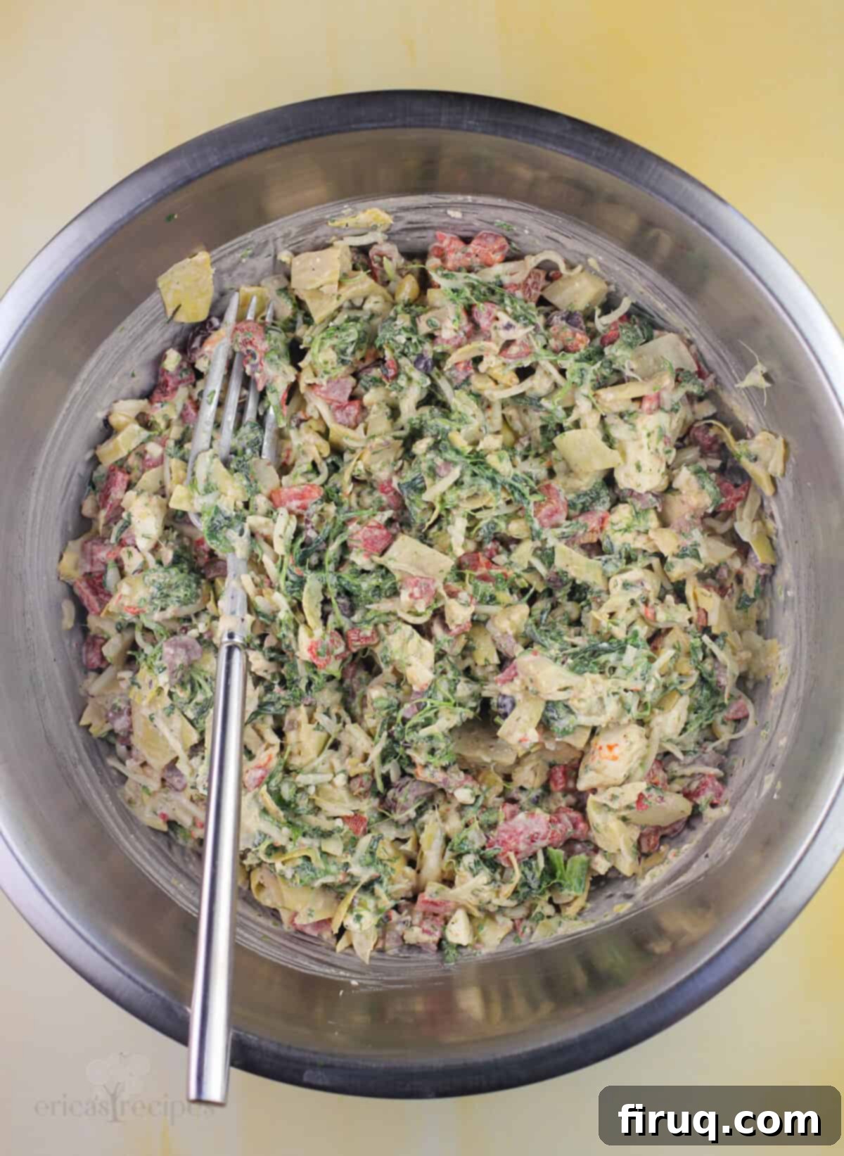Mediterranean Crescent Wreath 5 Mediterranean crescent ring filling ingredients being mixed in a bowl with a fork