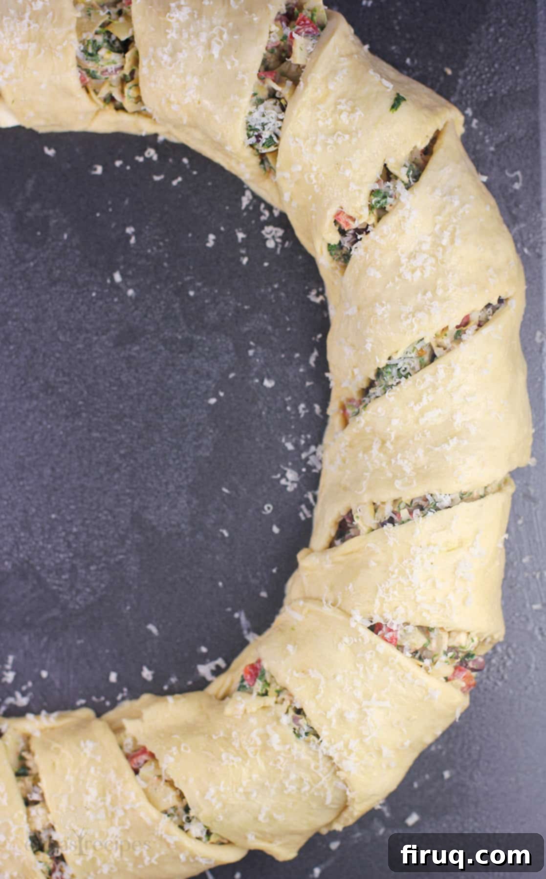 Mediterranean Crescent Wreath 9 Mediterranean crescent ring, fully assembled and topped with parmesan cheese, ready for baking