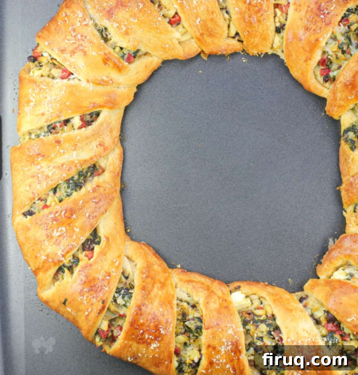 Mediterranean Crescent Wreath 10 A freshly baked Mediterranean crescent ring, golden brown and perfectly cooked, sitting on a metal bake sheet