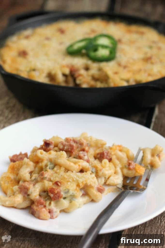 Fiery Chorizo Macaroni Bake 6 A serving of Jalapeno and Chorizo Macaroni and Cheese on a plate, garnished with fresh jalapeno slices.