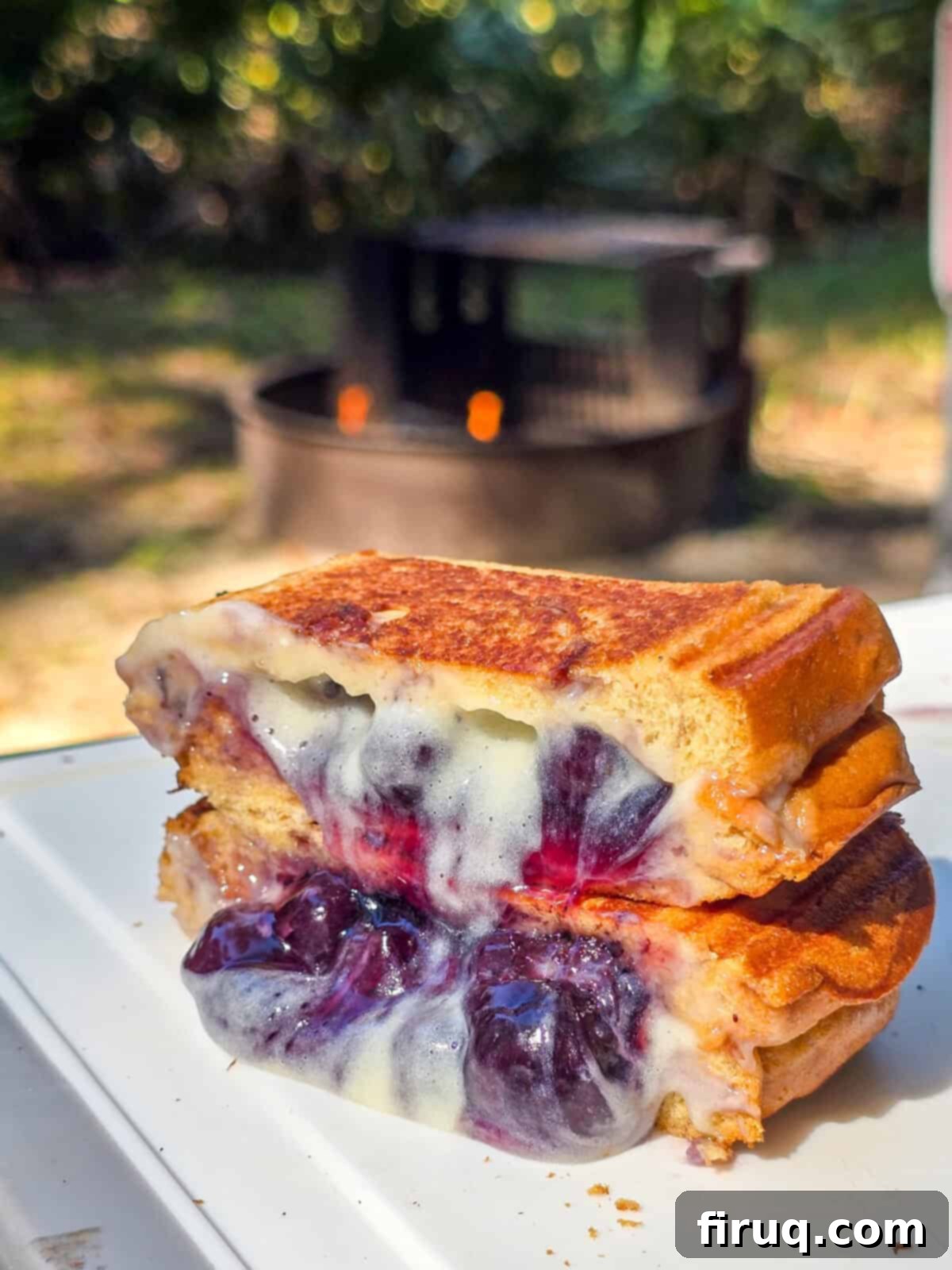 cross-section of blueberry brulee hand pie showing the toasty bread and creamy fillings